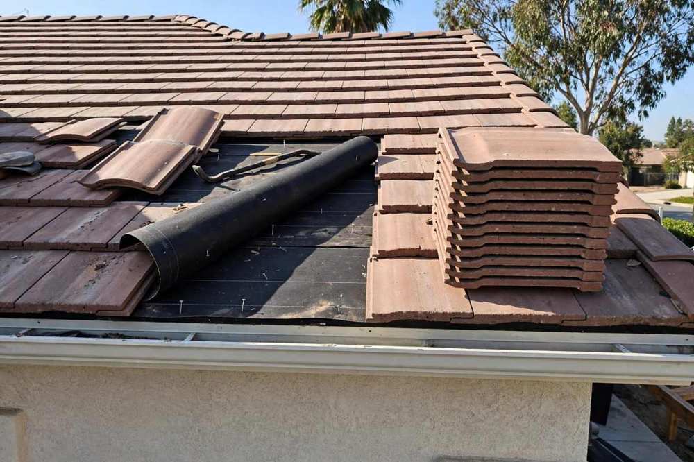 Concrete tile roof being repaired